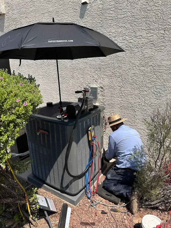 HVAC technician performing outdoor AC maintenance in Pepper Pike